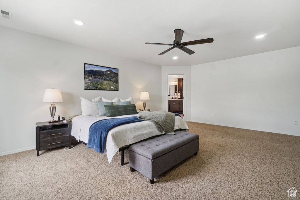 Bedroom featuring light colored carpet, recessed lighting, ensuite bathroom, ceiling fan, and baseboards