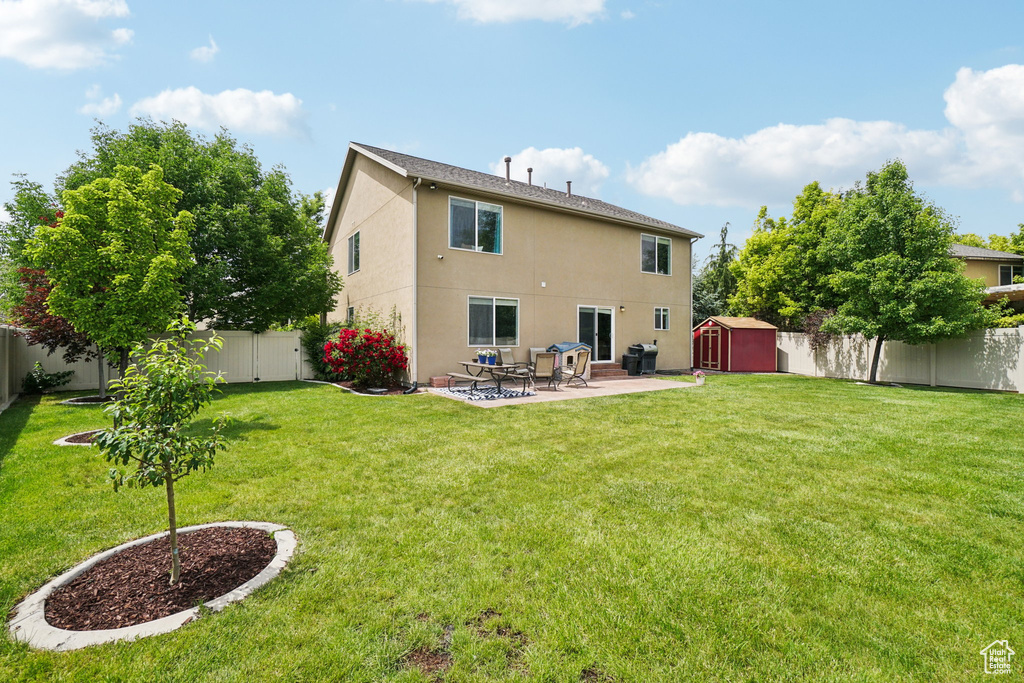 Rear view of house with a patio area and stucco siding