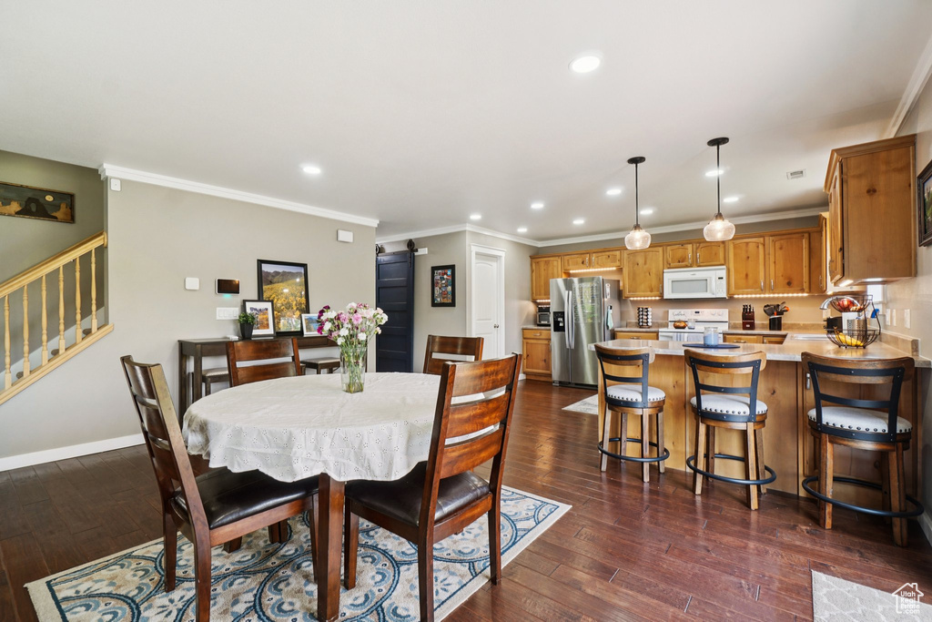 Dining space with stairway, recessed lighting, dark wood-style flooring, and crown molding