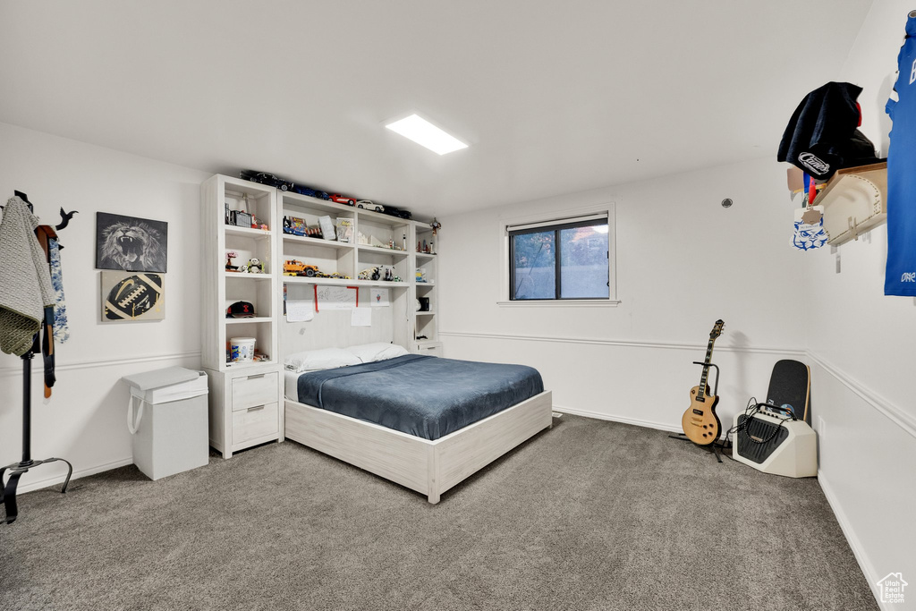 Carpeted bedroom featuring baseboards