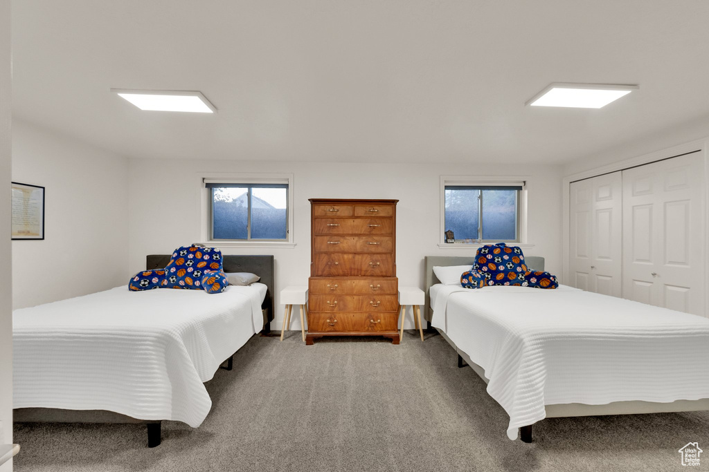 Bedroom featuring carpet flooring and a closet