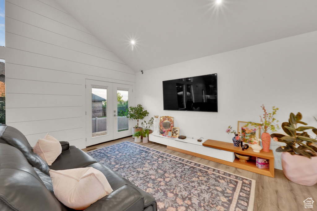 Living area featuring wood finished floors, french doors, high vaulted ceiling, and recessed lighting