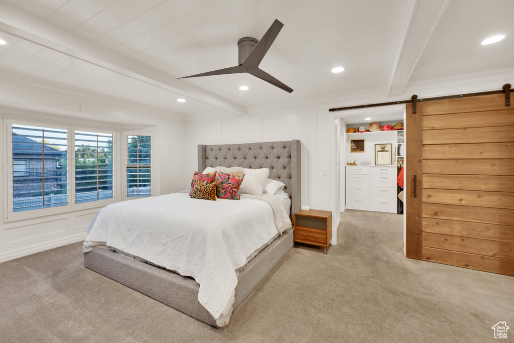 Carpeted bedroom featuring beamed ceiling, a barn door, recessed lighting, and ceiling fan