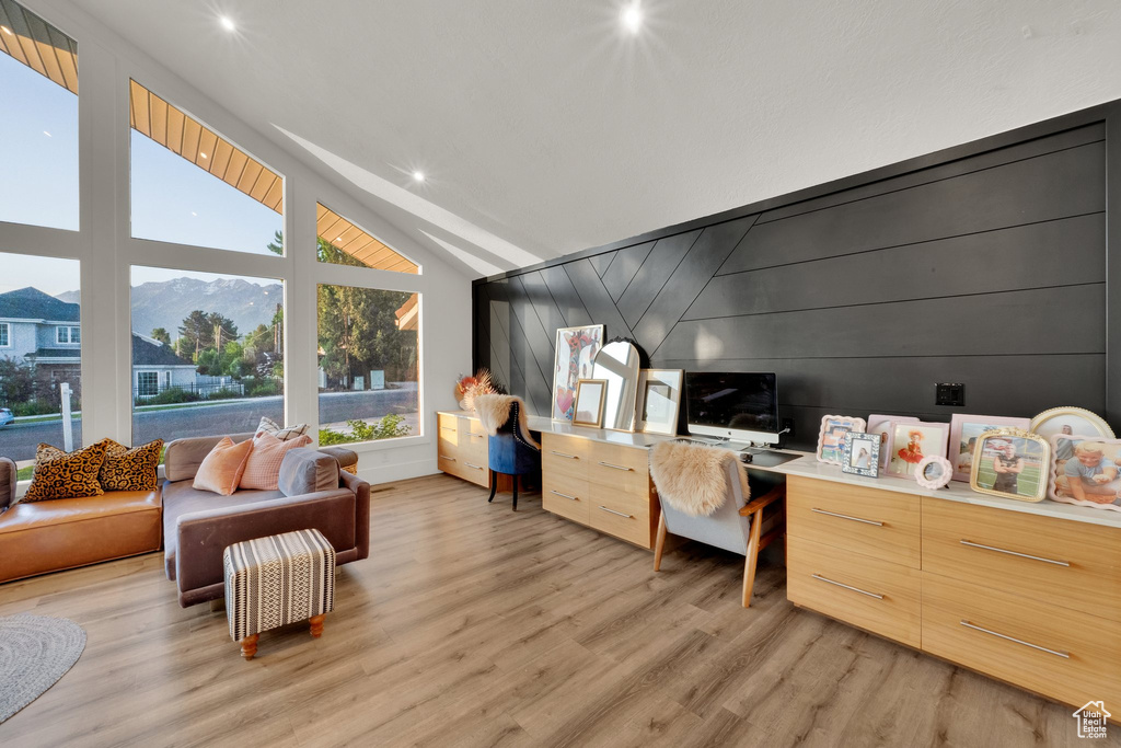 Home office with vaulted ceiling, light wood-style floors, recessed lighting, and a mountain view