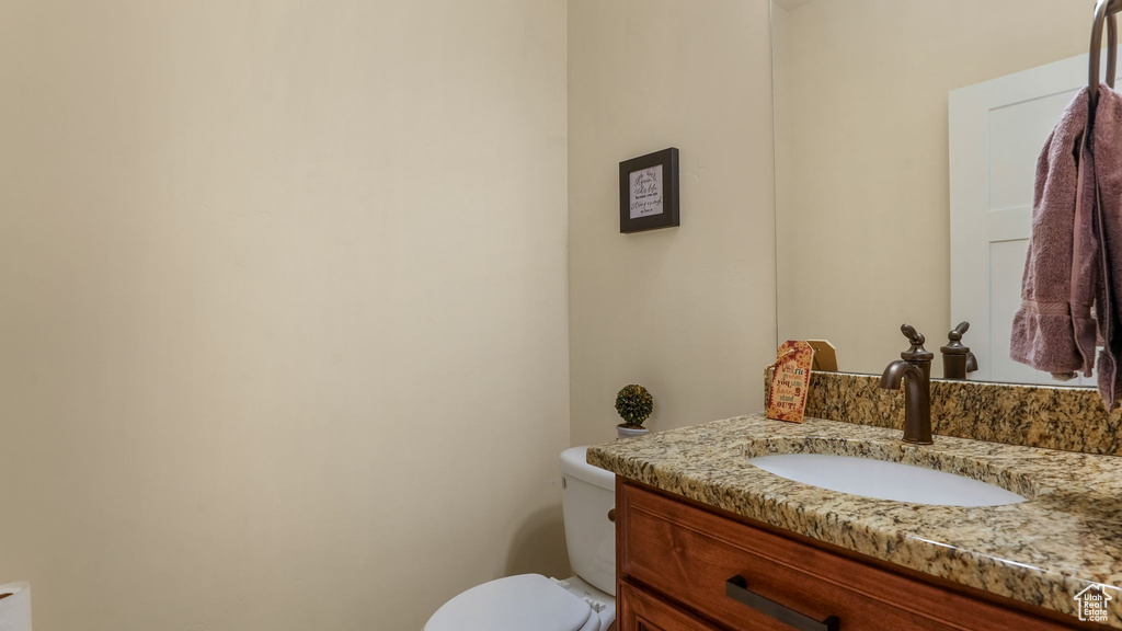 Half bathroom with vanity and toilet