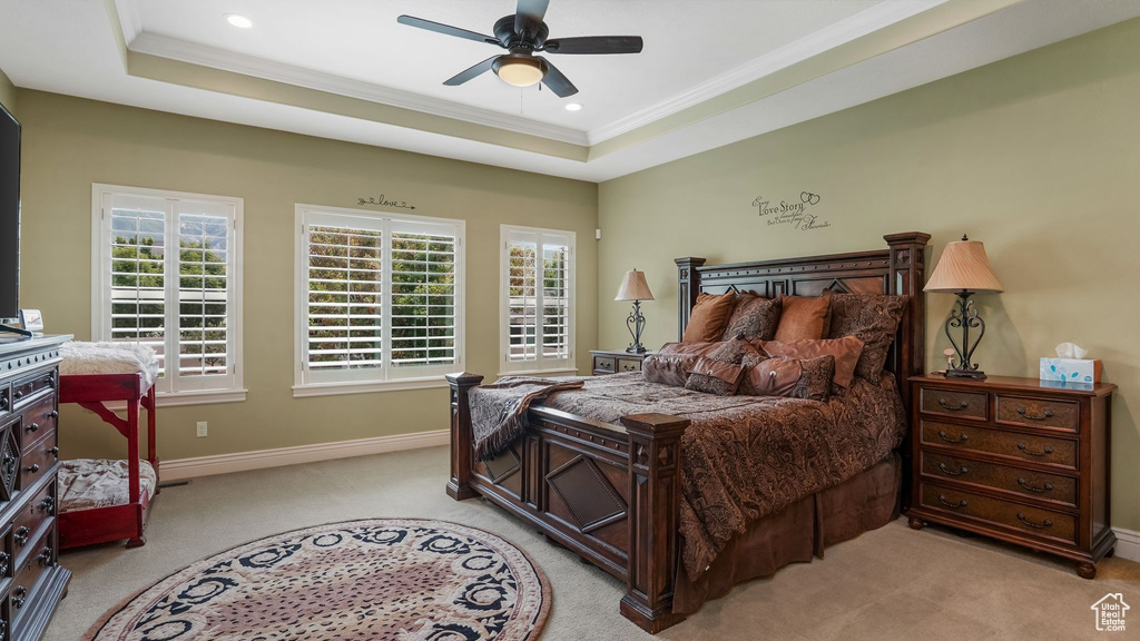 Bedroom featuring light colored carpet, crown molding, baseboards, a raised ceiling, and recessed lighting