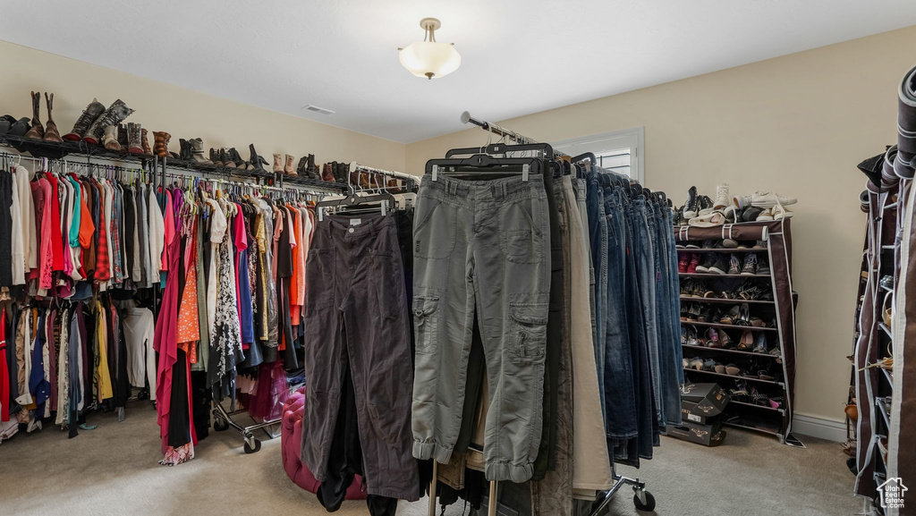 Walk in closet with carpet