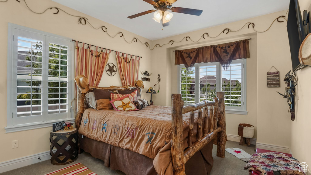 Bedroom featuring carpet, baseboards, and ceiling fan