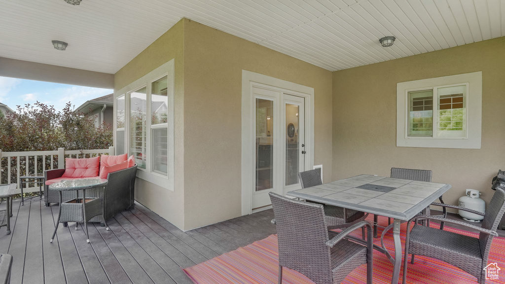 Wooden deck featuring outdoor dining area