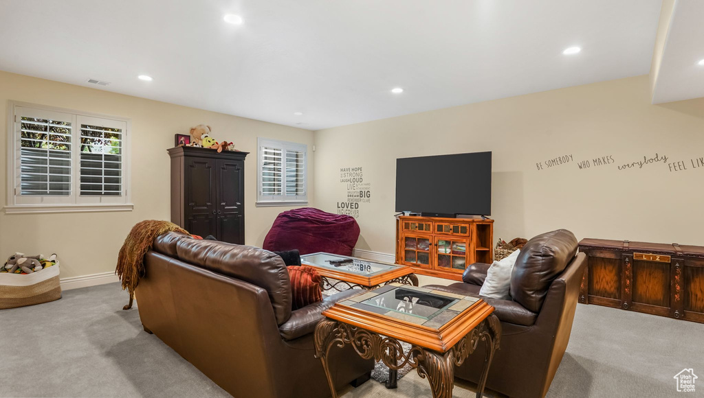 Carpeted living room with recessed lighting and baseboards