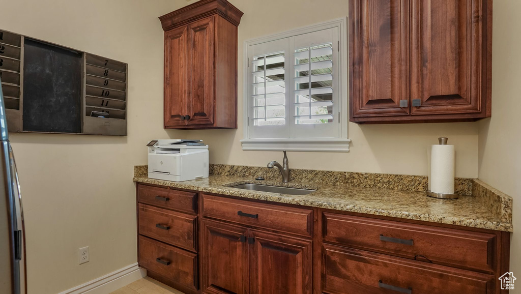 Kitchen featuring a sink and light stone countertops