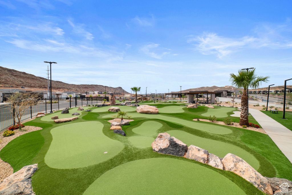 View of community featuring a putting area, a mountain view, and a gazebo