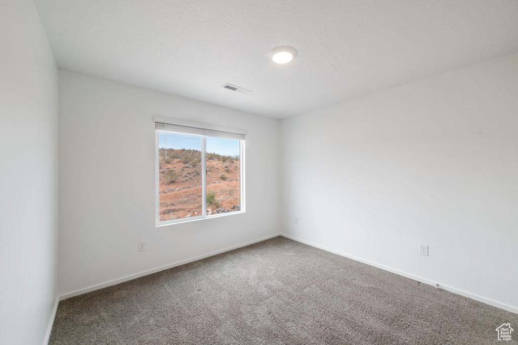 Unfurnished room with carpet and baseboards