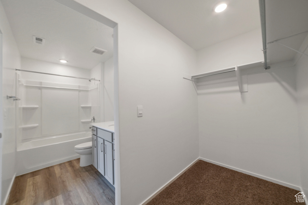 Spacious closet with wood finished floors
