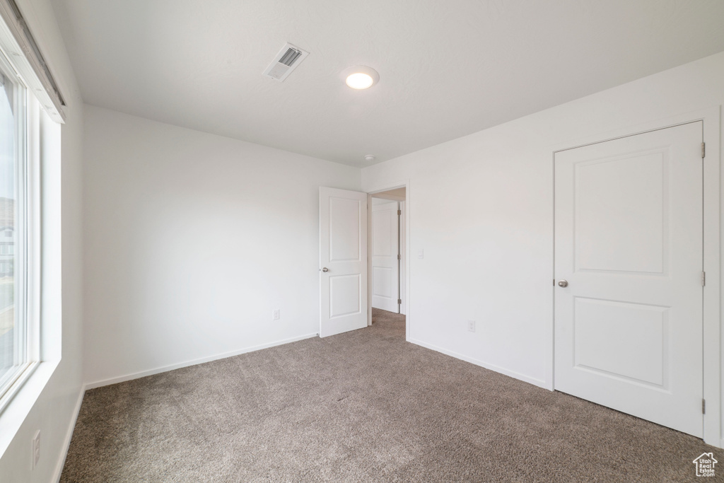 Unfurnished bedroom featuring carpet flooring, baseboards, and recessed lighting