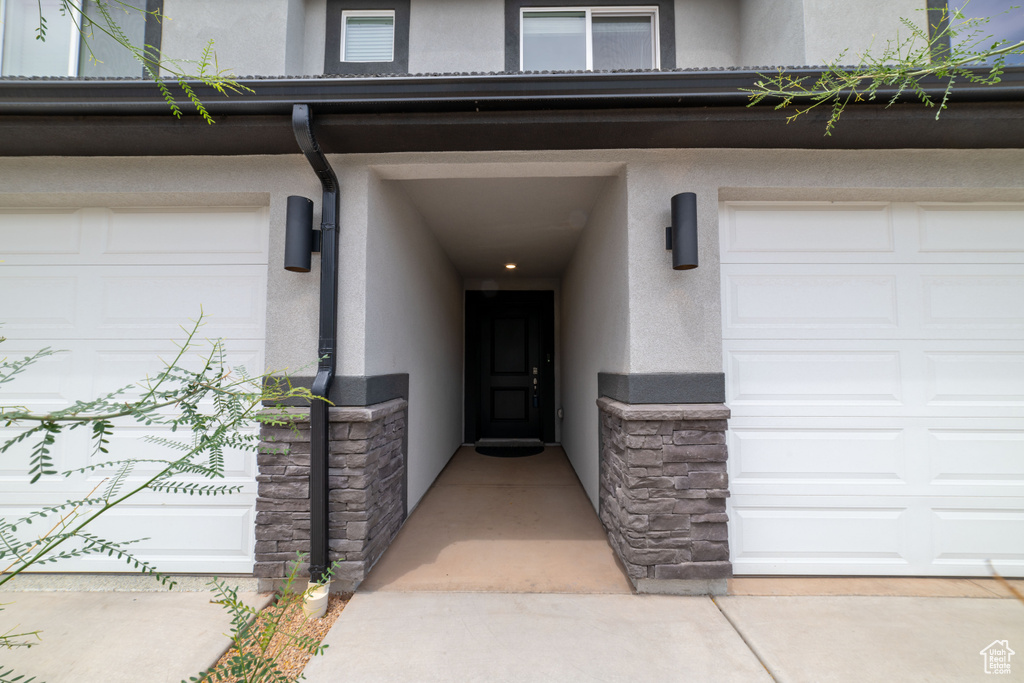 Property entrance featuring stucco siding and stone siding