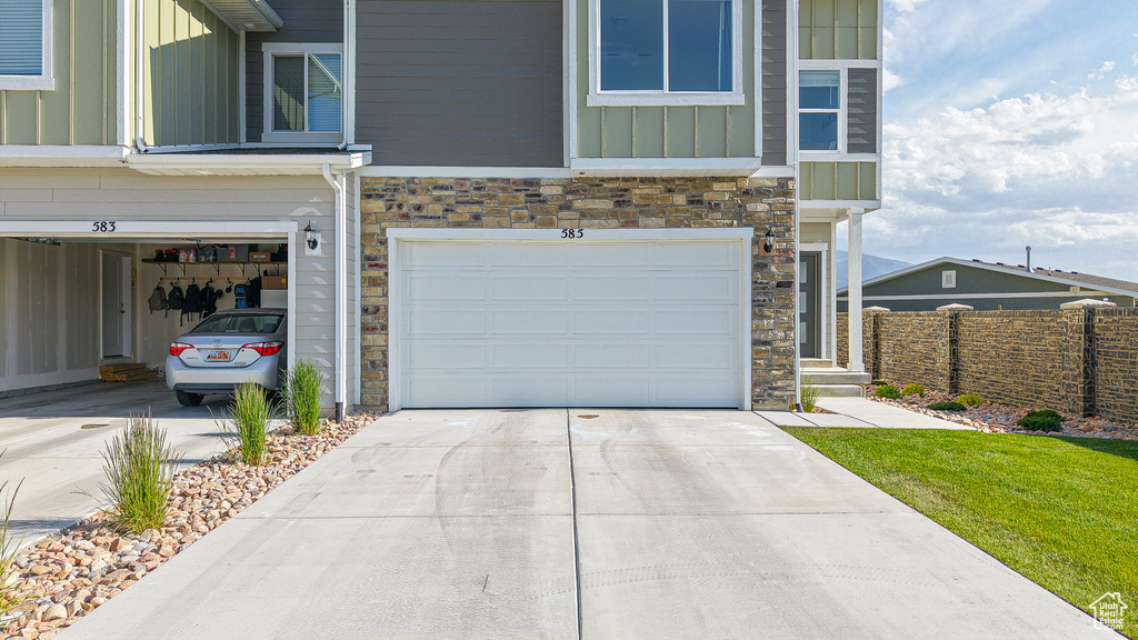 Garage featuring concrete driveway
