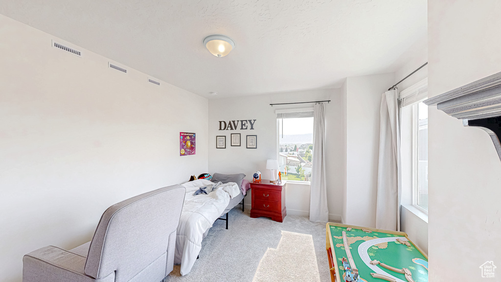 Bedroom featuring light colored carpet