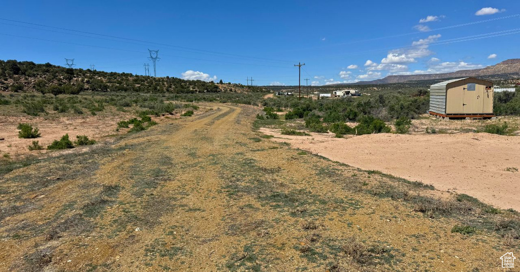View of dirt / gravel road featuring a mountain view