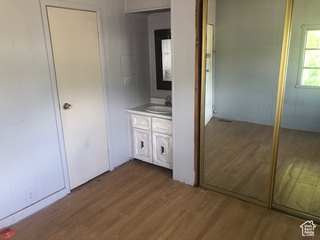 Unfurnished bedroom with dark wood-type flooring and a sink