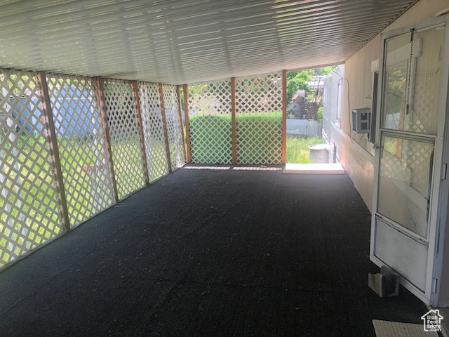Unfurnished sunroom with cooling unit