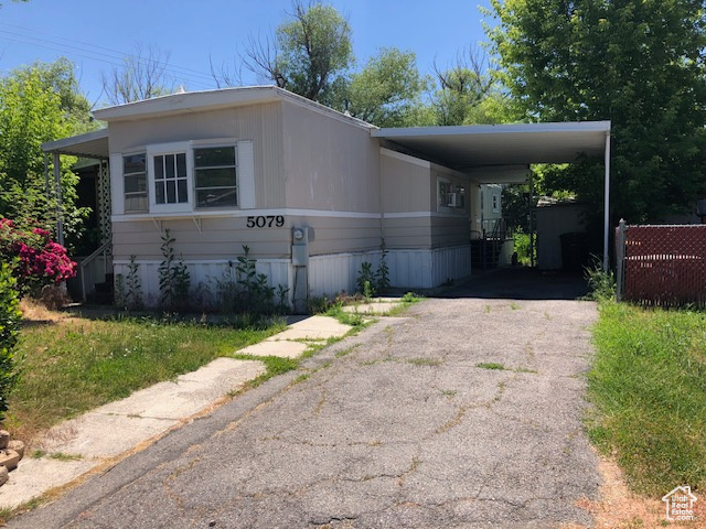 Manufactured / mobile home featuring driveway and an attached carport