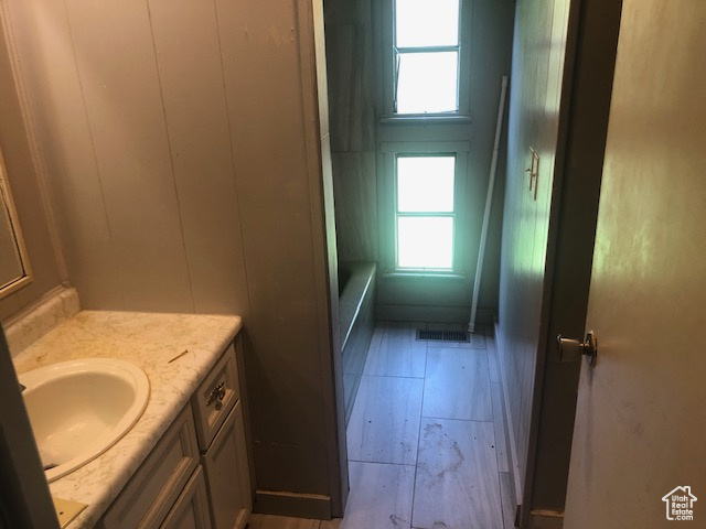 Full bathroom with plenty of natural light and vanity