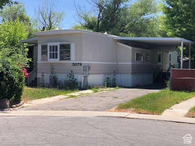 Manufactured / mobile home featuring driveway and a carport