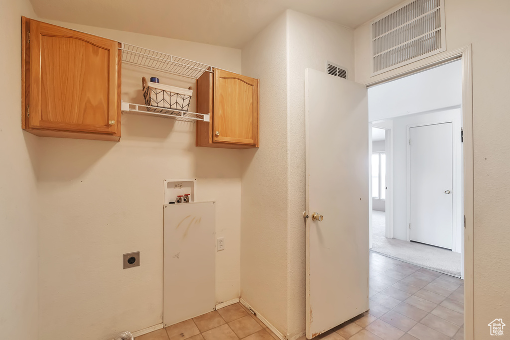 Laundry room featuring washer hookup, hookup for an electric dryer, and cabinet space