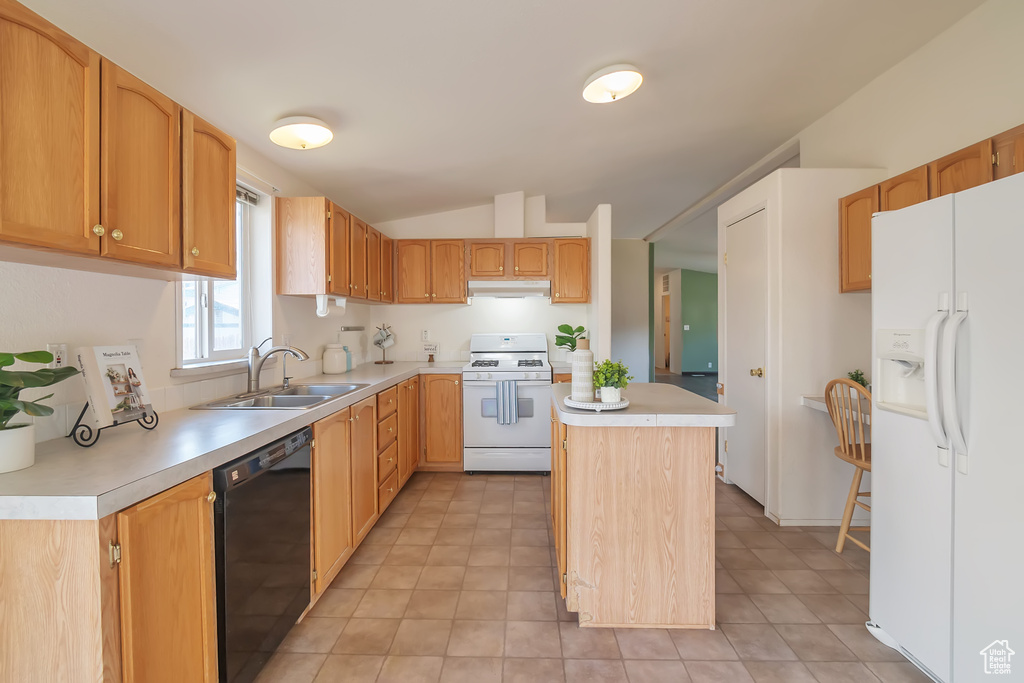 Kitchen featuring white appliances, a sink, light countertops, lofted ceiling, and a center island