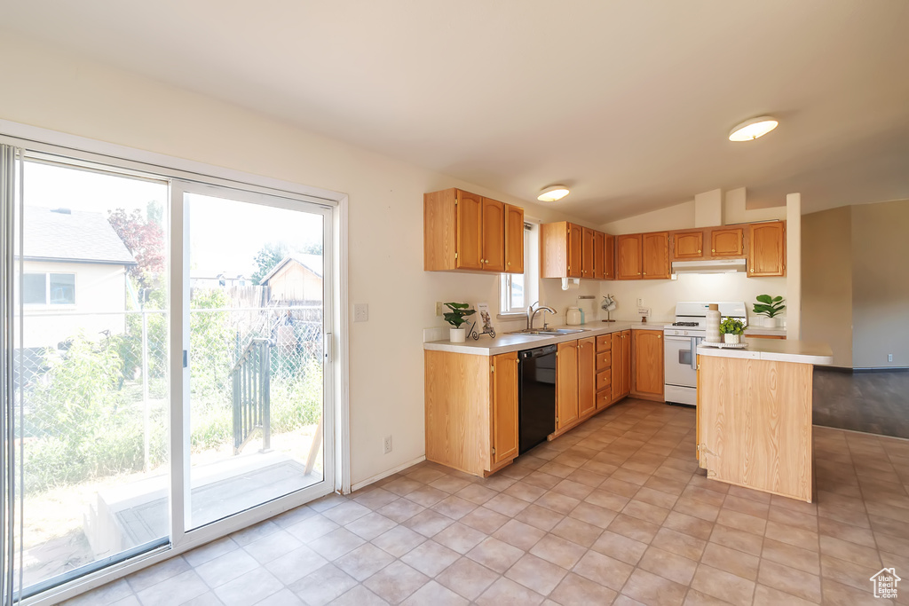 Kitchen with gas range gas stove, dishwasher, light countertops, under cabinet range hood, and vaulted ceiling