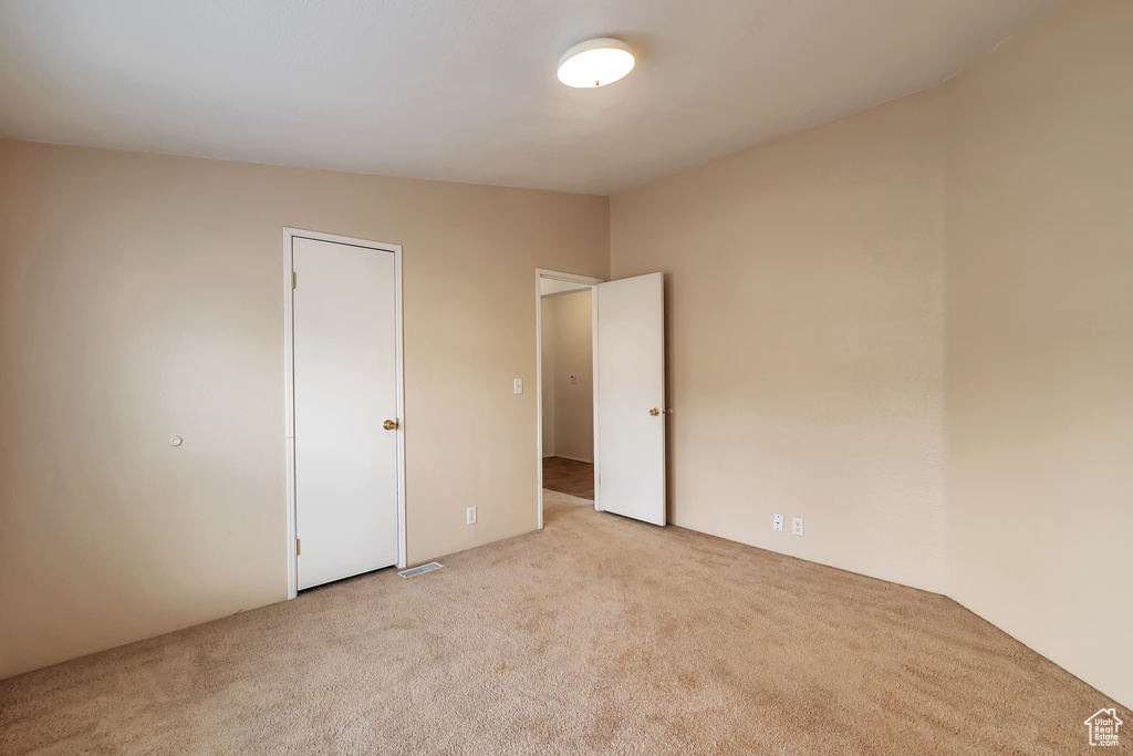 Unfurnished bedroom with carpet flooring