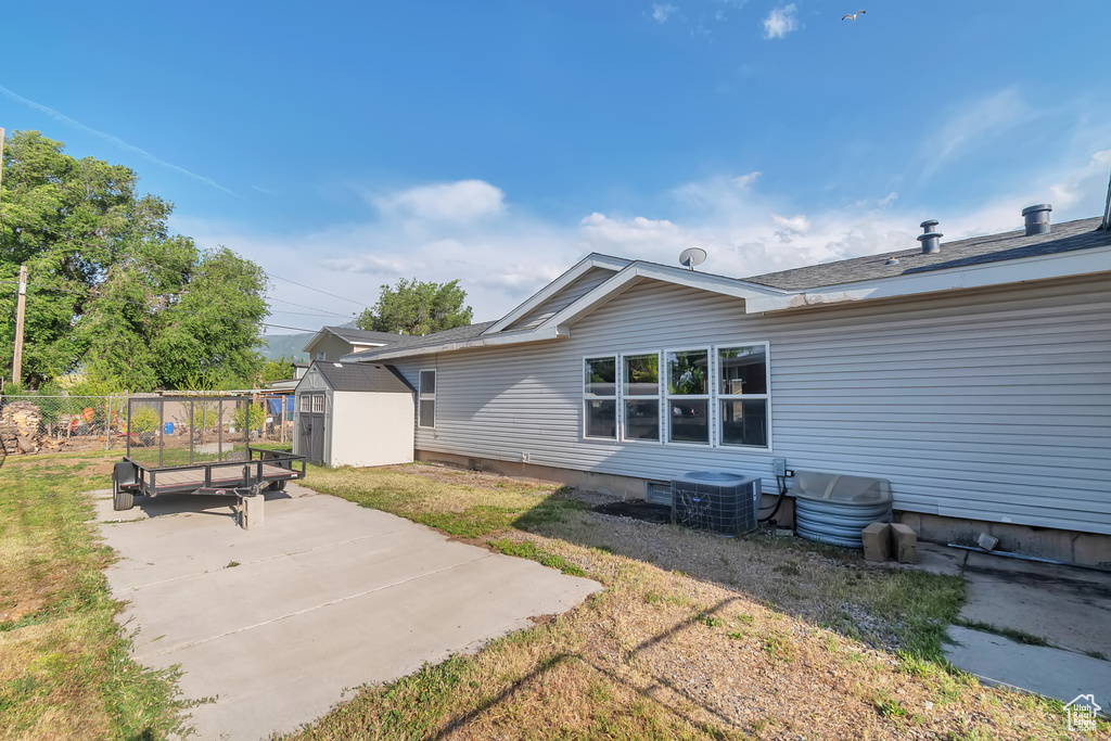 Back of house featuring central air condition unit and a patio