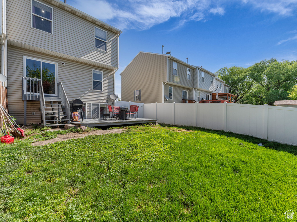 Rear view of house featuring a wooden deck
