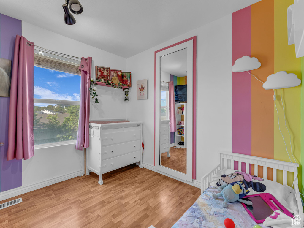 Bedroom featuring wood finished floors and baseboards