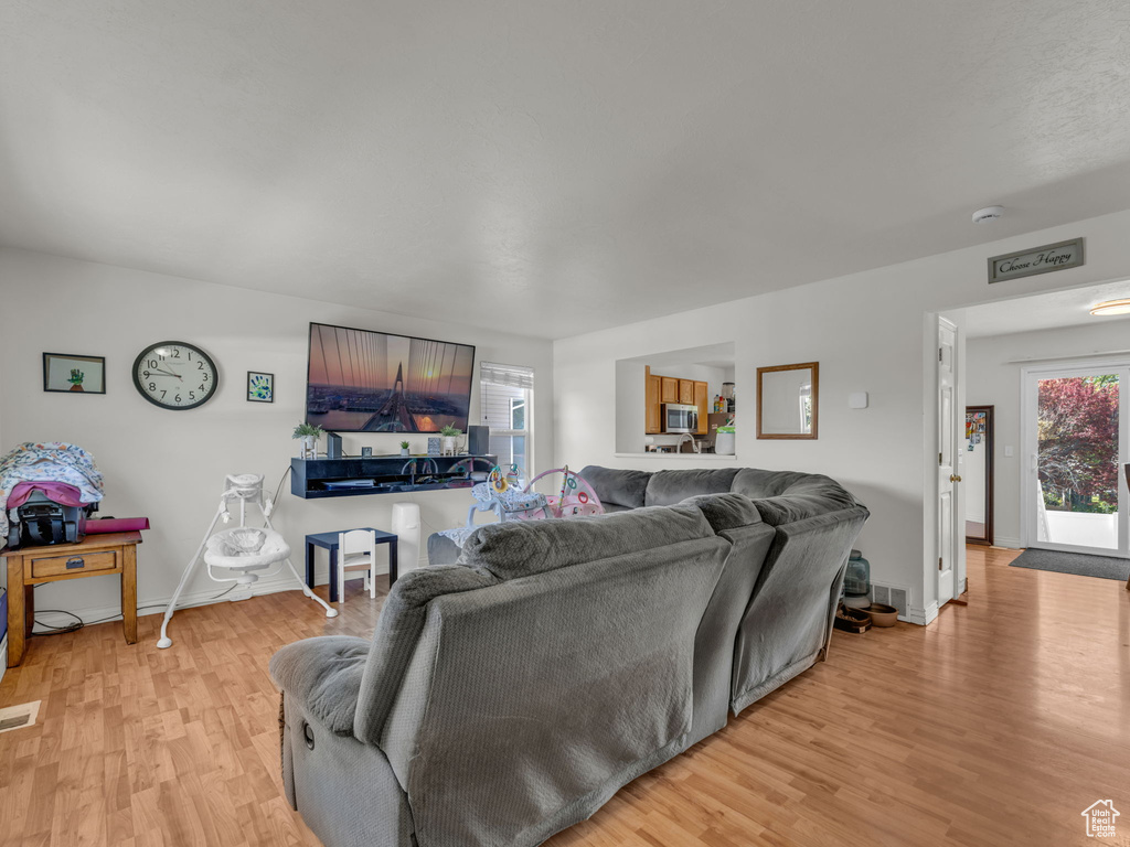 Living area featuring light wood-style flooring and baseboards