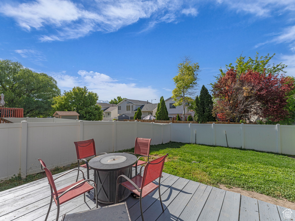 Wooden deck with outdoor dining area and a residential view