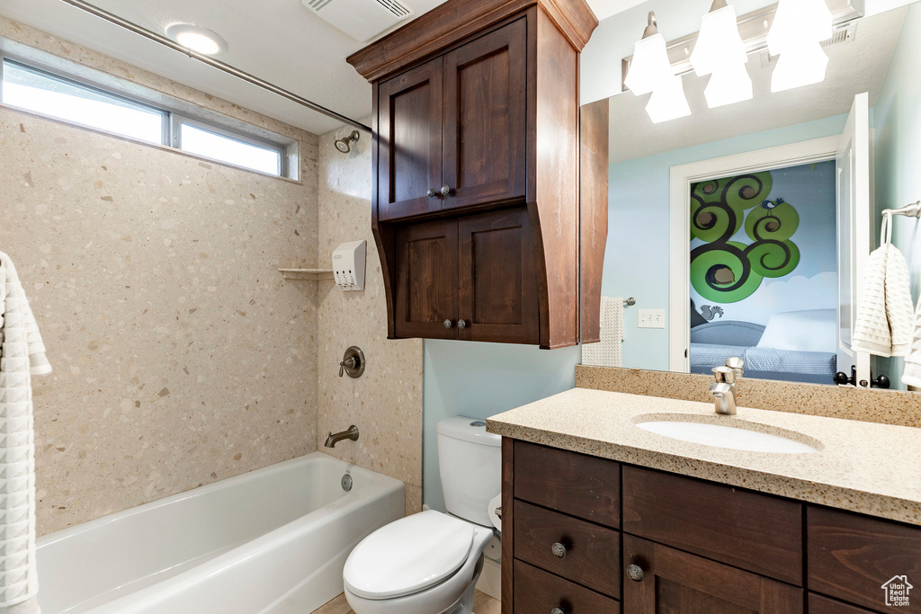 Full bathroom with shower / bath combination, toilet, vanity, and ensuite bath