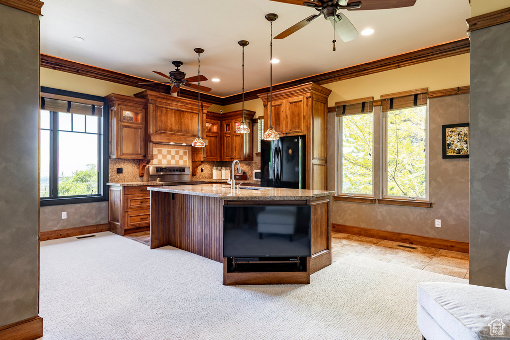 Kitchen with ceiling fan, freestanding refrigerator, crown molding, baseboards, and stainless steel electric range oven