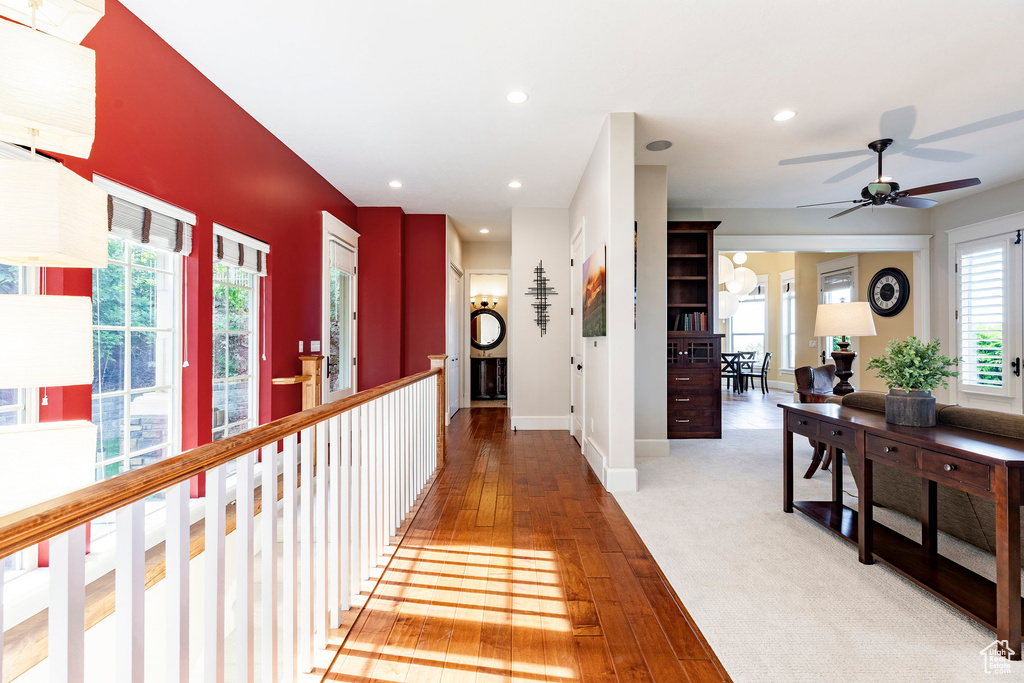 Hallway with light wood-style floors, recessed lighting, and baseboards