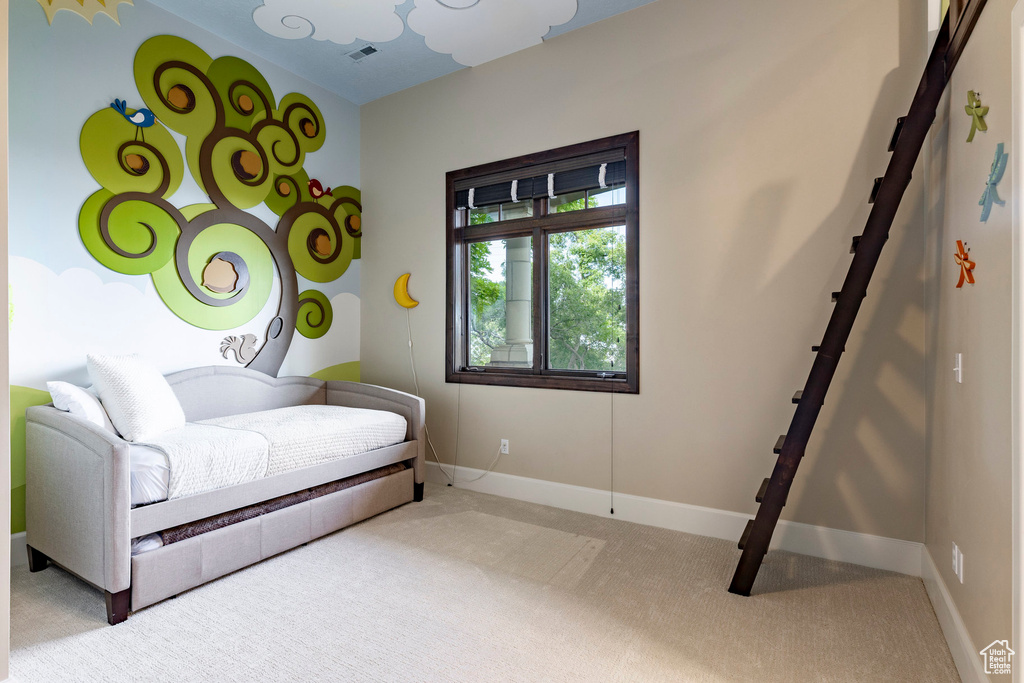 Carpeted bedroom featuring baseboards