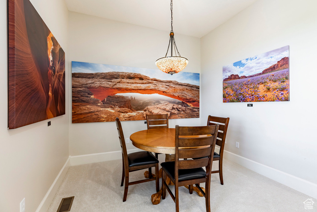 Carpeted dining area with baseboards