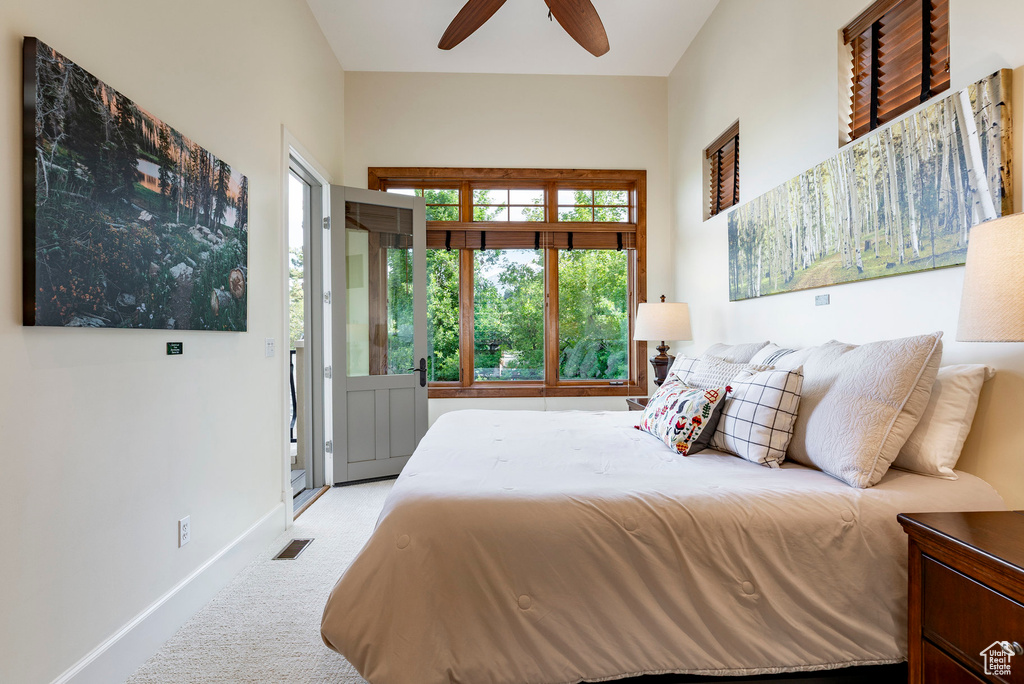 Carpeted bedroom with baseboards and a ceiling fan