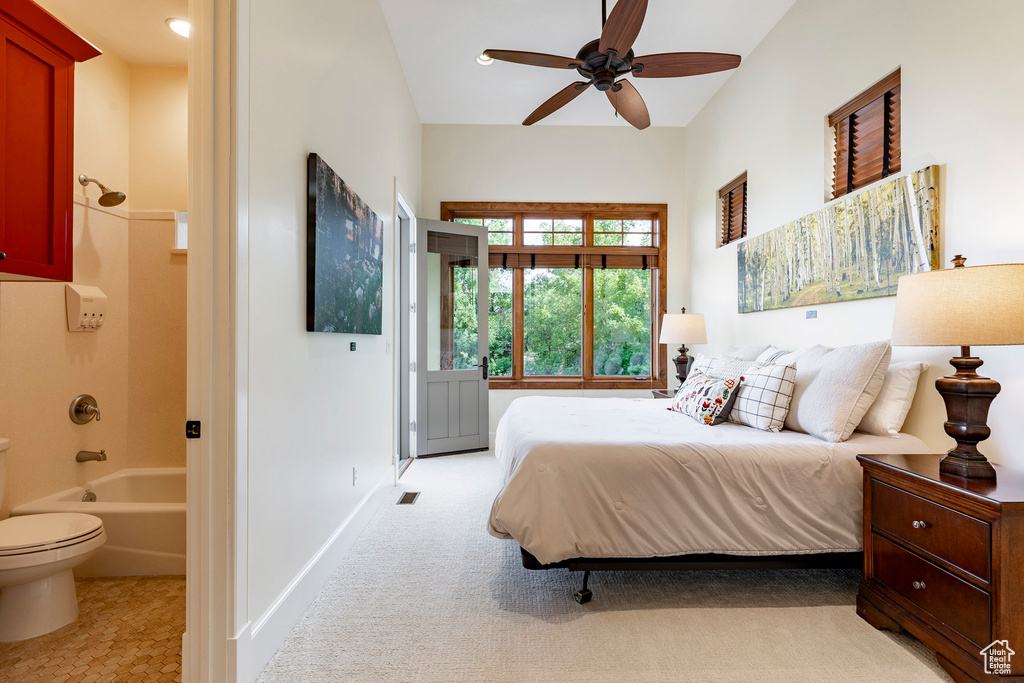 Bedroom featuring ensuite bathroom and baseboards