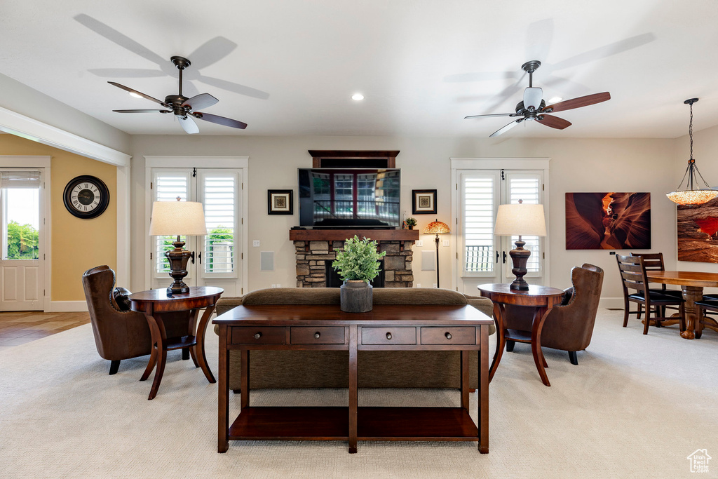 Living room featuring a ceiling fan, plenty of natural light, light carpet, and recessed lighting