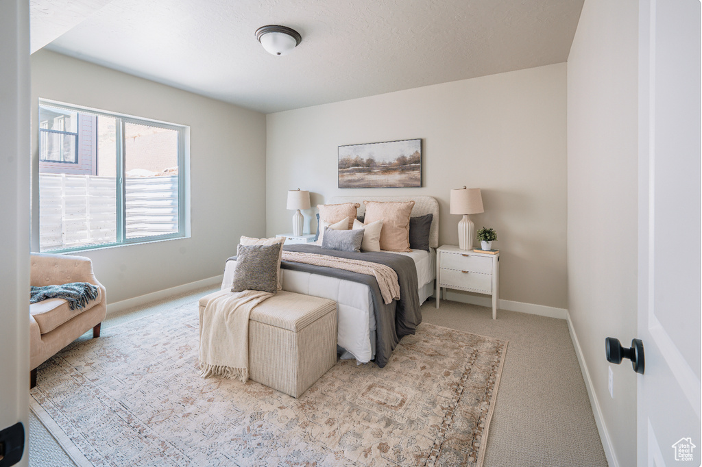 Bedroom featuring carpet and baseboards