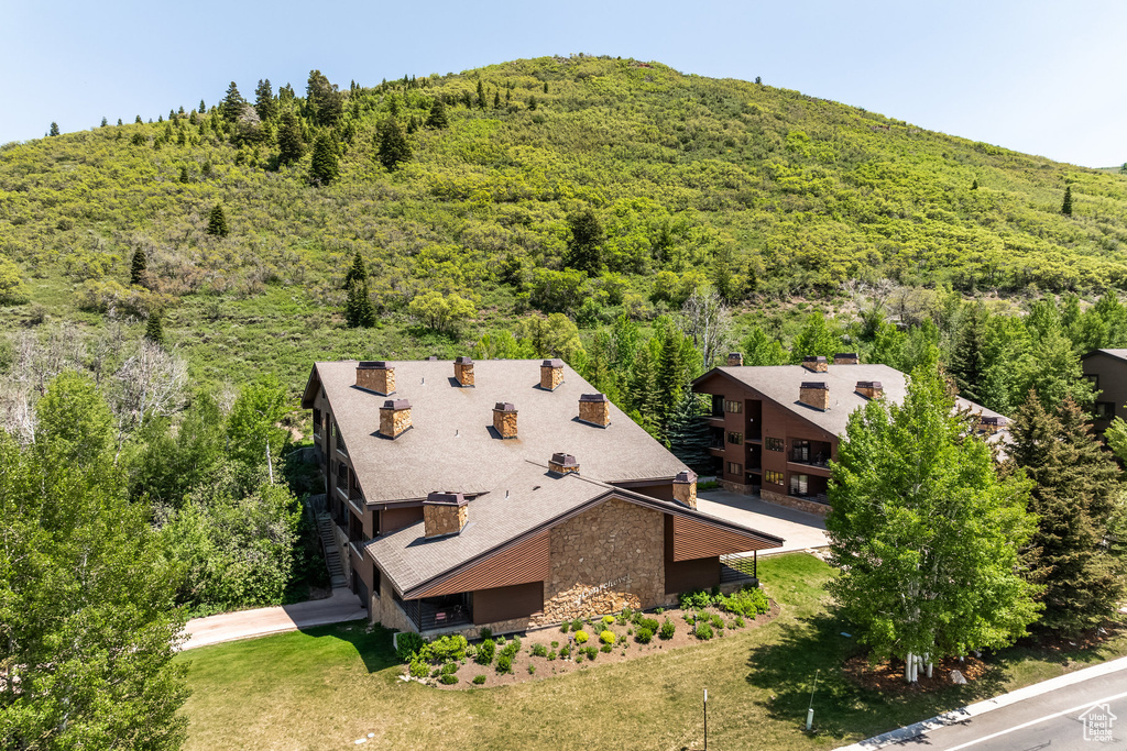 Aerial view of property and surrounding area with a forest