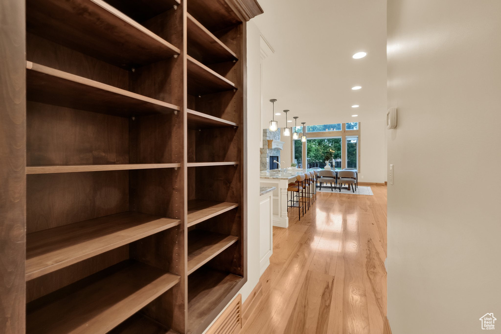Hallway featuring light wood-type flooring and recessed lighting