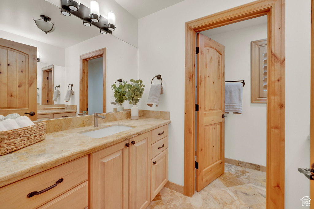 Bathroom with vanity and baseboards