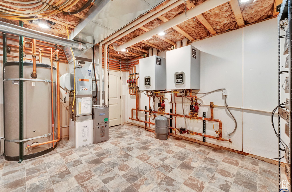 Utilities featuring tankless water heater and heating unit